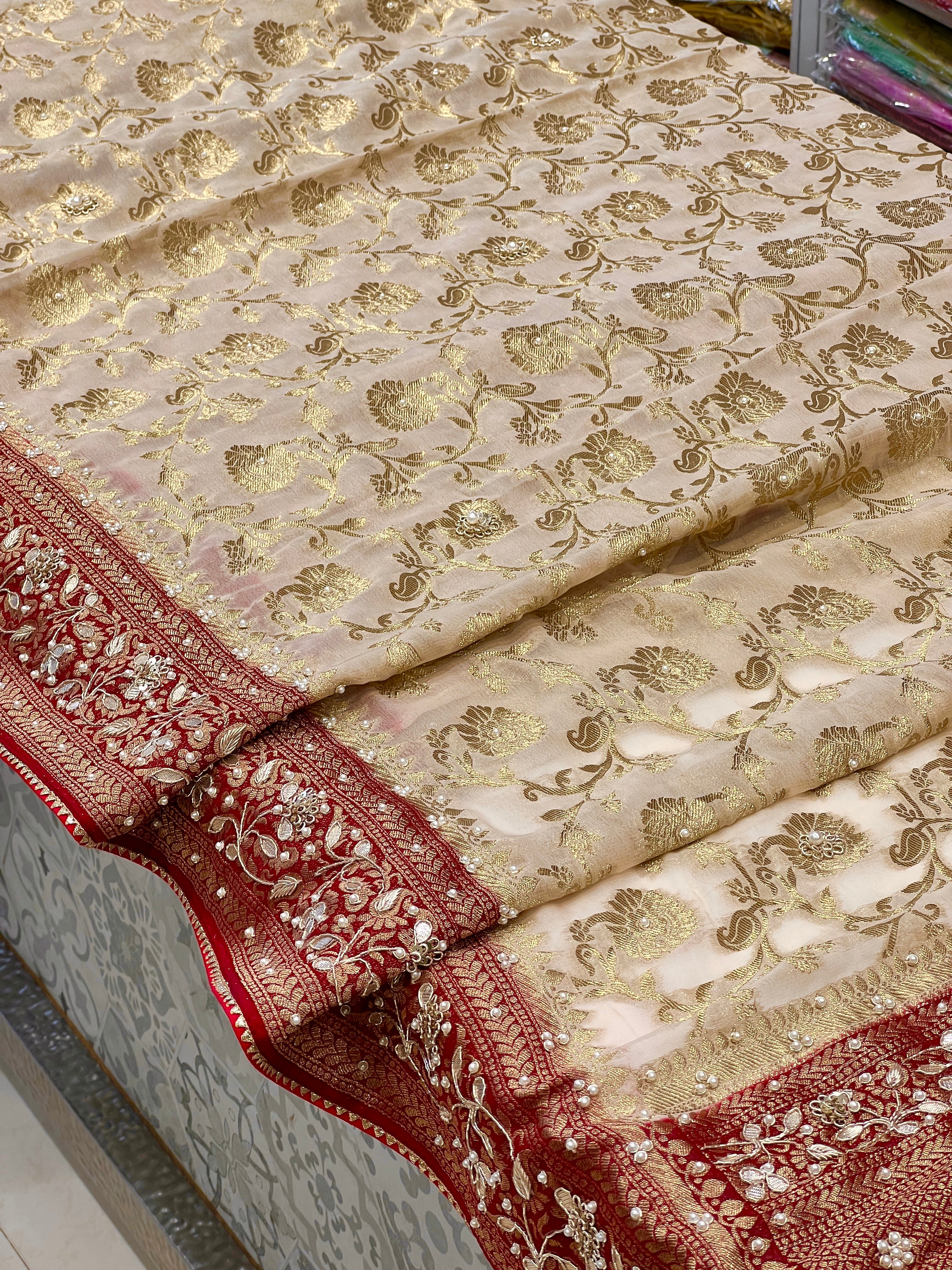Beige Georgette Jaal Saree with Moti Hand Embroidery and Red Border