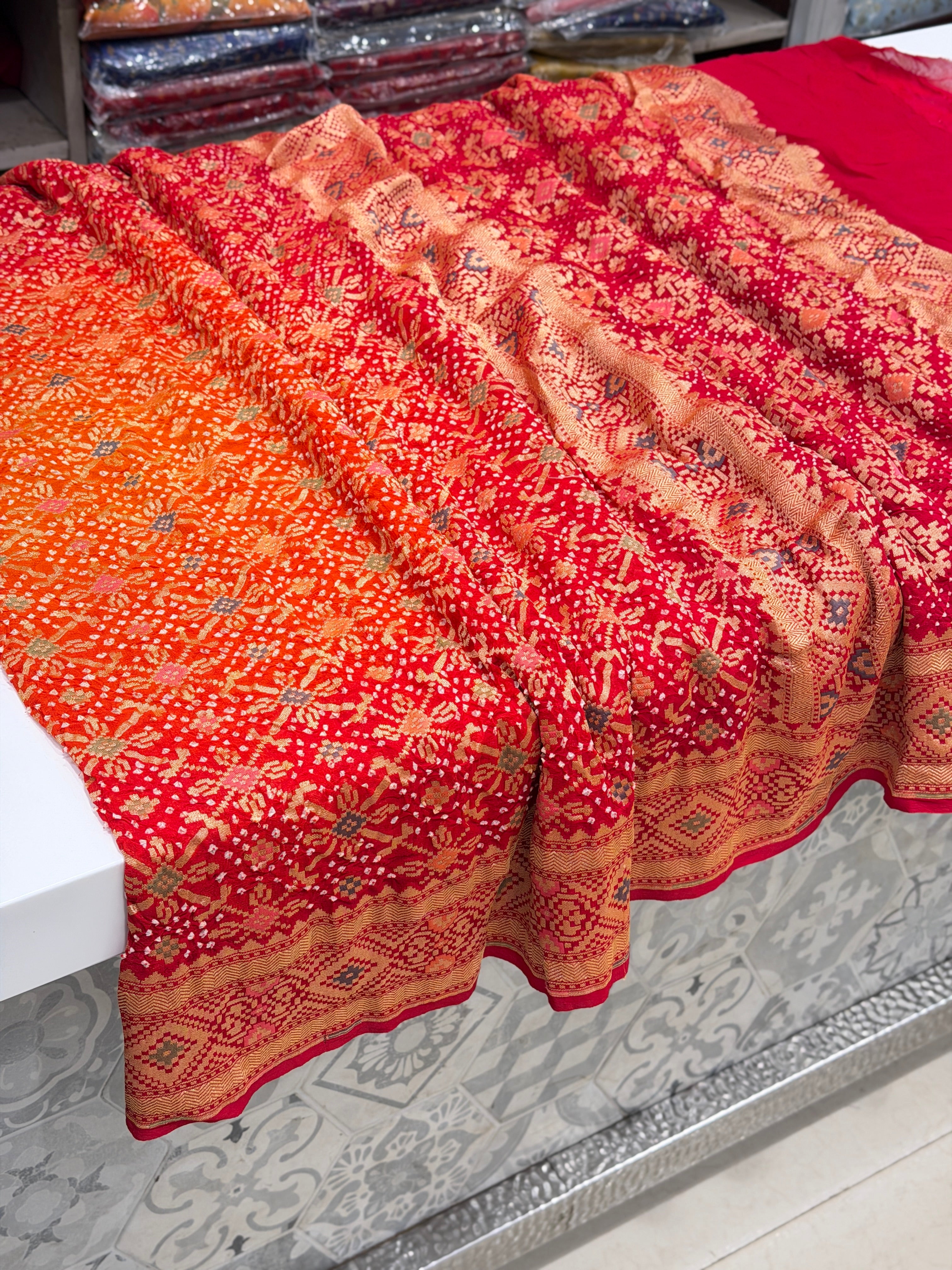 Shaded Orange Red Patola Weave Meenakari Georgette Bandhej Saree