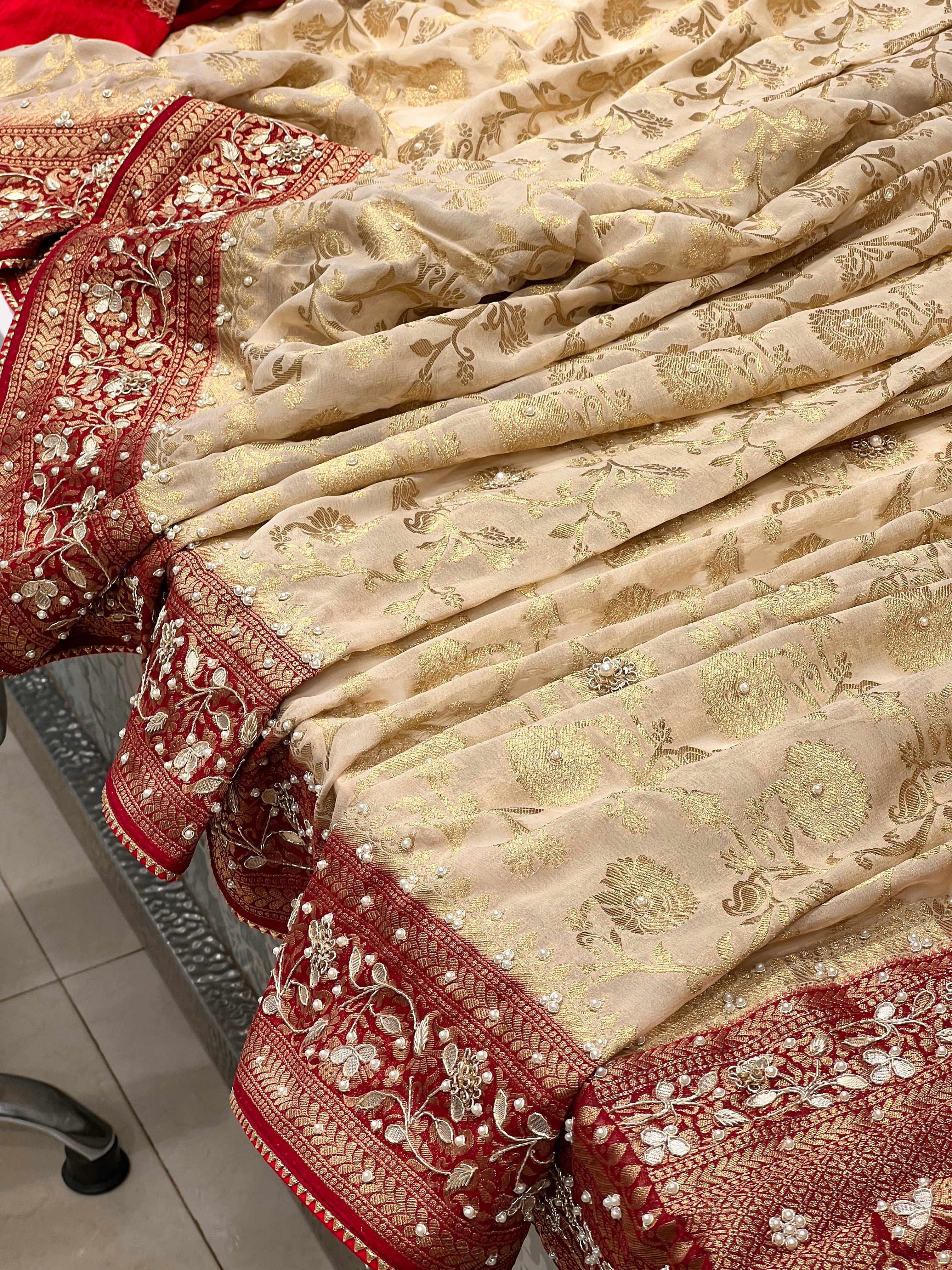 Beige Georgette Jaal Saree with Moti Hand Embroidery and Red Border