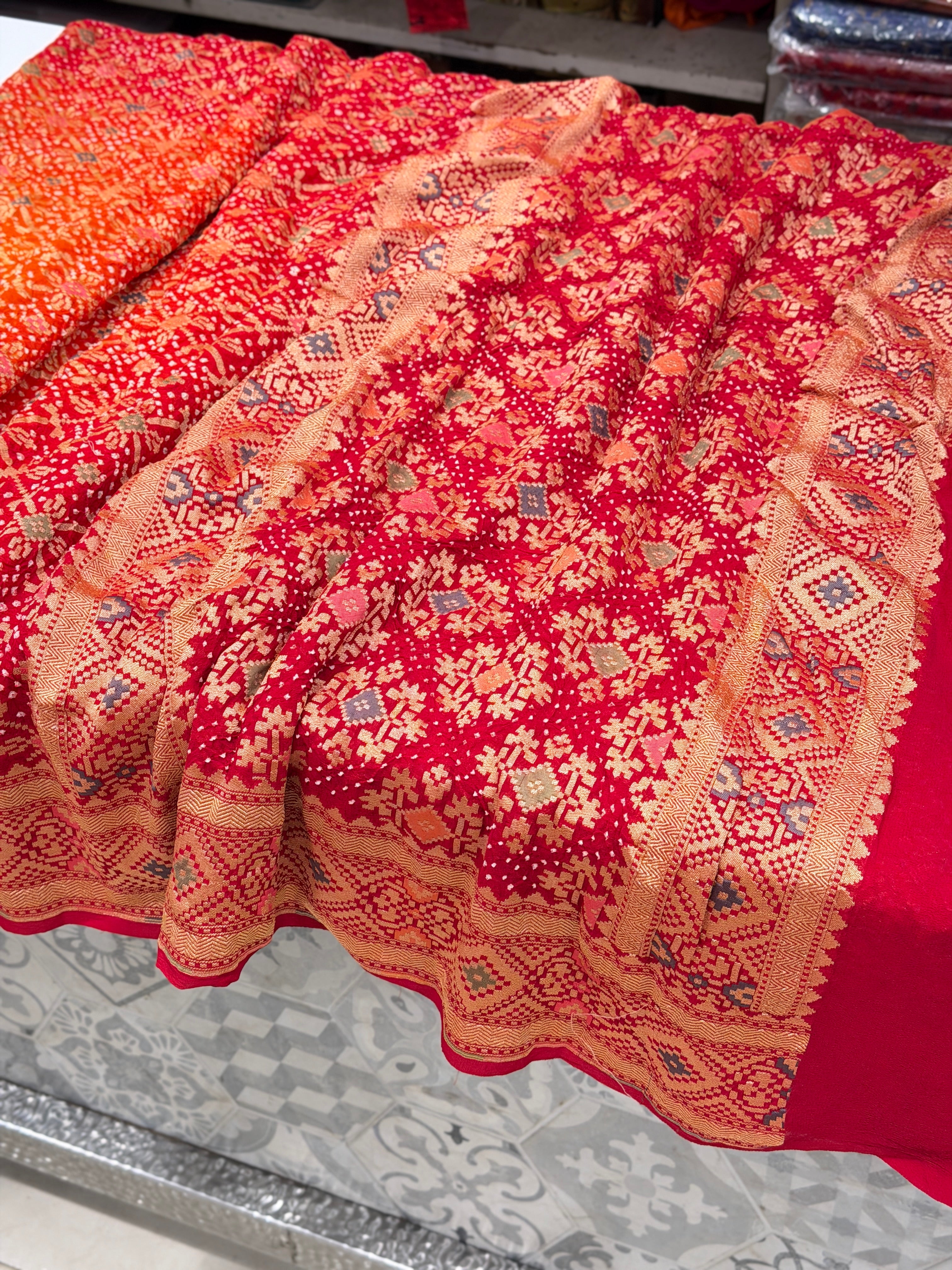 Shaded Orange Red Patola Weave Meenakari Georgette Bandhej Saree